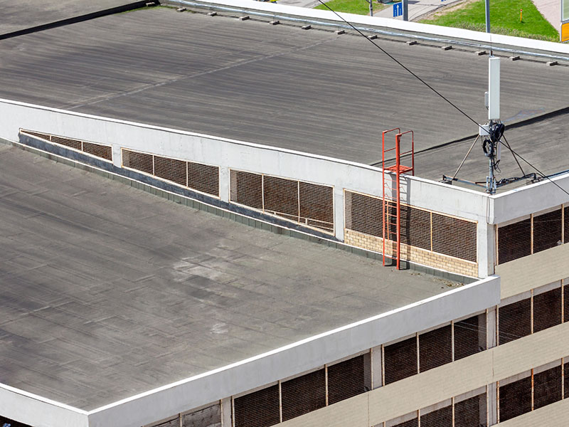 Top view of a commercial building showing a gray flat roof